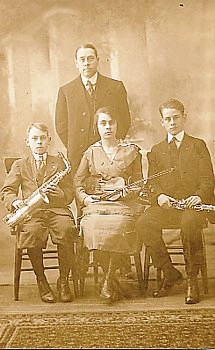 Featured is a real photo postcard image from the early 20th century depicting a (family?) group of individuals with their respective musical instruments (which would now be antiques!).  The original real photo postcard is for sale in The unltd.com Store.
